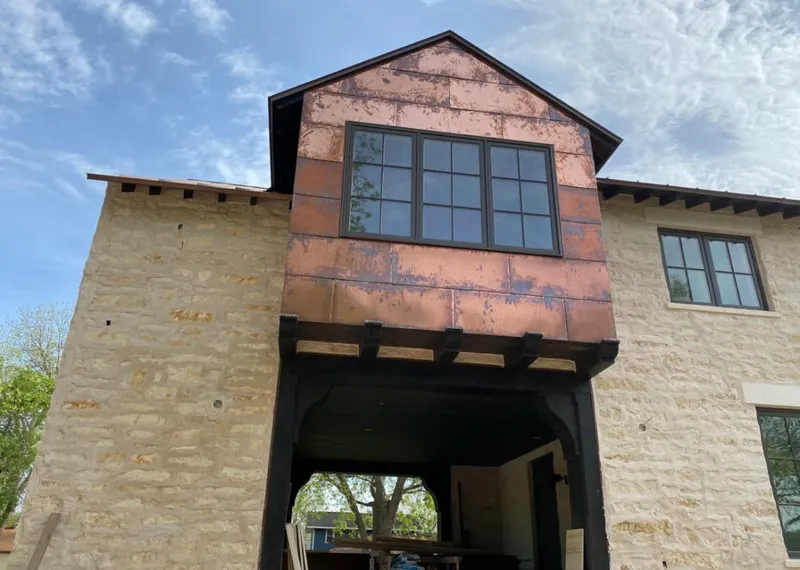 Copper metal panel facade on a stone building for Skylight Installation in Wauchula